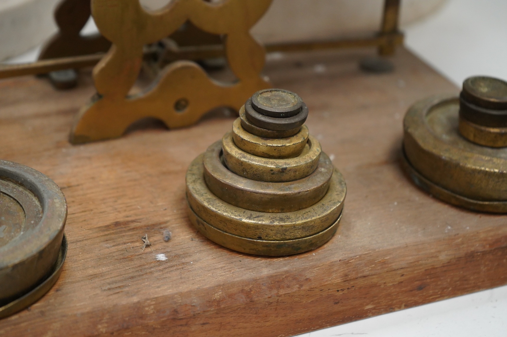 A set of brass and mahogany Avery postal scales and weights, 37cm wide